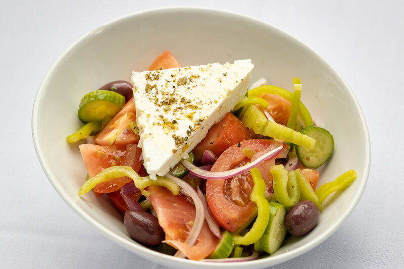 Salad with tomatoes, cucumbers, onions, peppers, feta cheese and olive oil