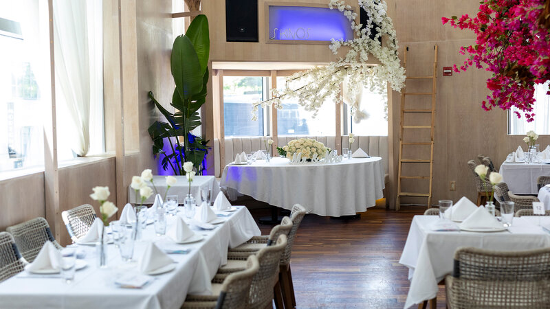 Dining room during the day with tables set for private event