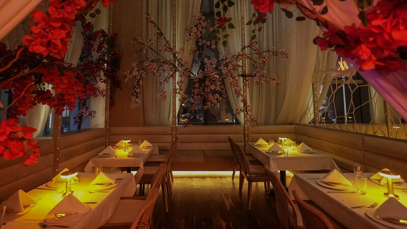 Santorini Room at night with candle lit tables and flower decorations