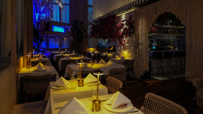 Dining room at night with tables set for private event